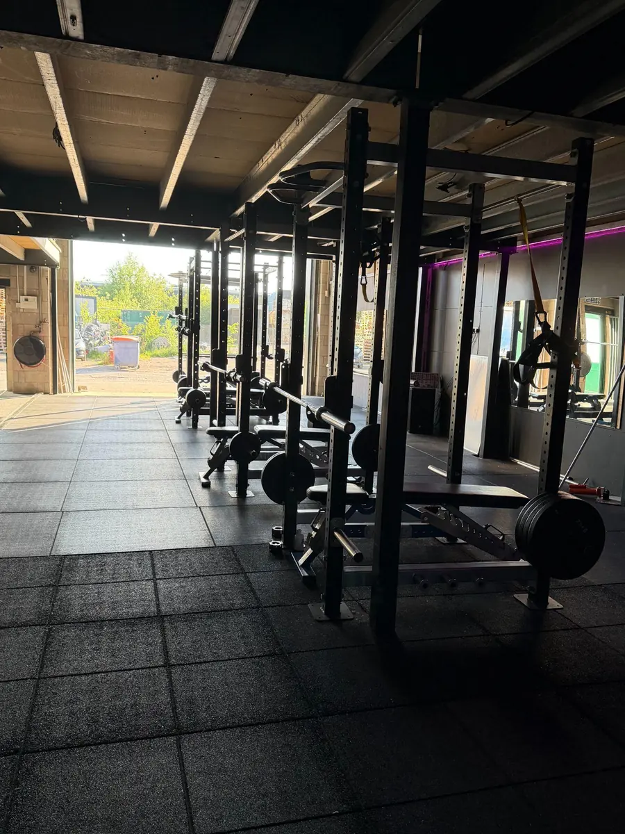 Squat racks along the rig, shutter open to the yard