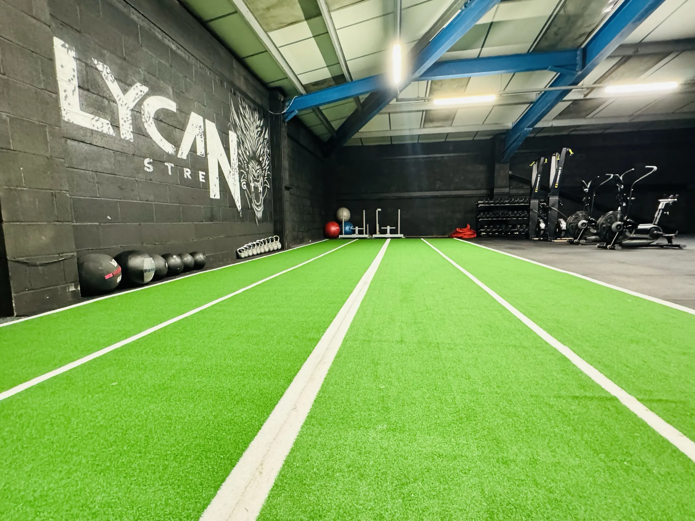 The turf sled track running the length of Lycan Strength to the Lycan wall