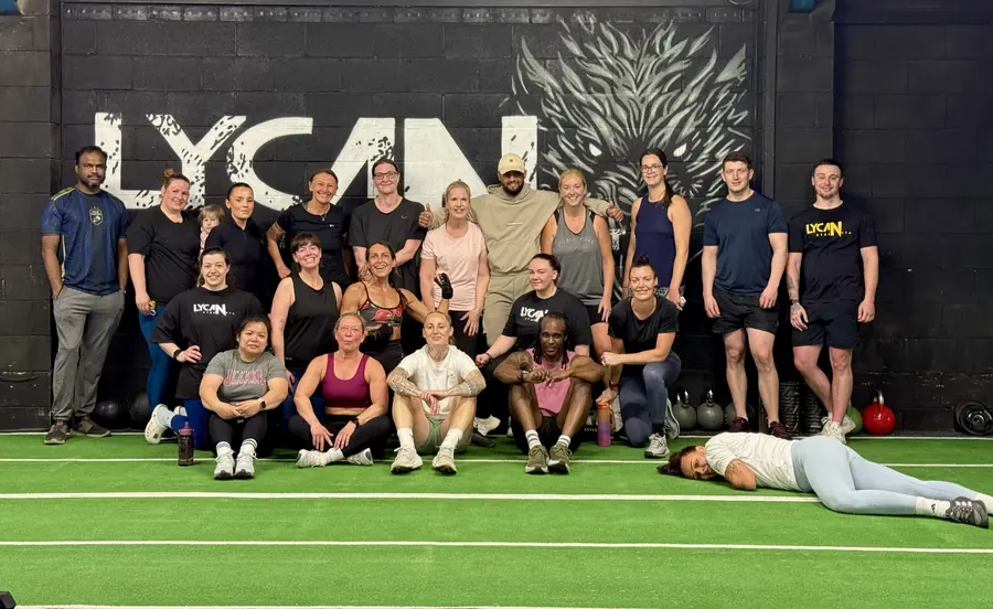 Members sitting on the turf after a class